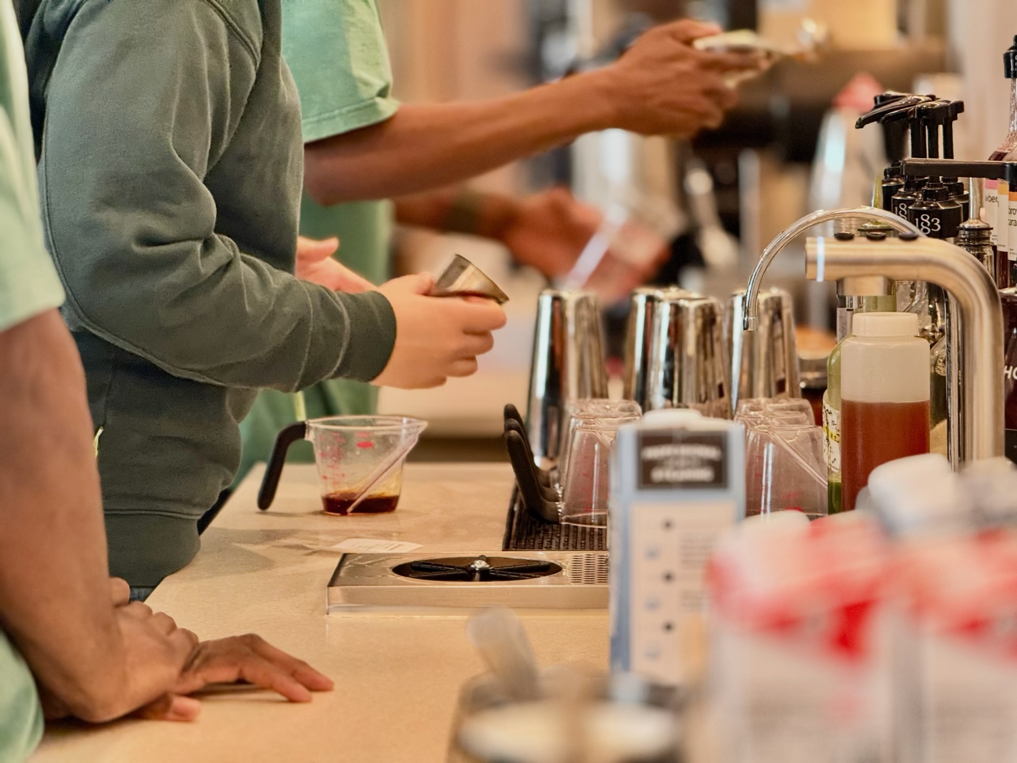 blank-street-baristas-hands-syrup-pour