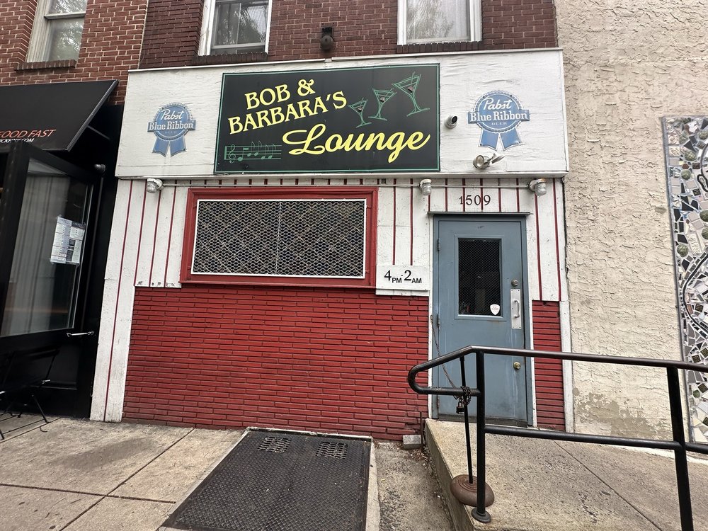 Exterior of Bob & Barbara's Lounge on South Street, with a black and yellow sign flanked by Pabst Blue Ribbon logos and a "4pm-2am" placard by the door.
